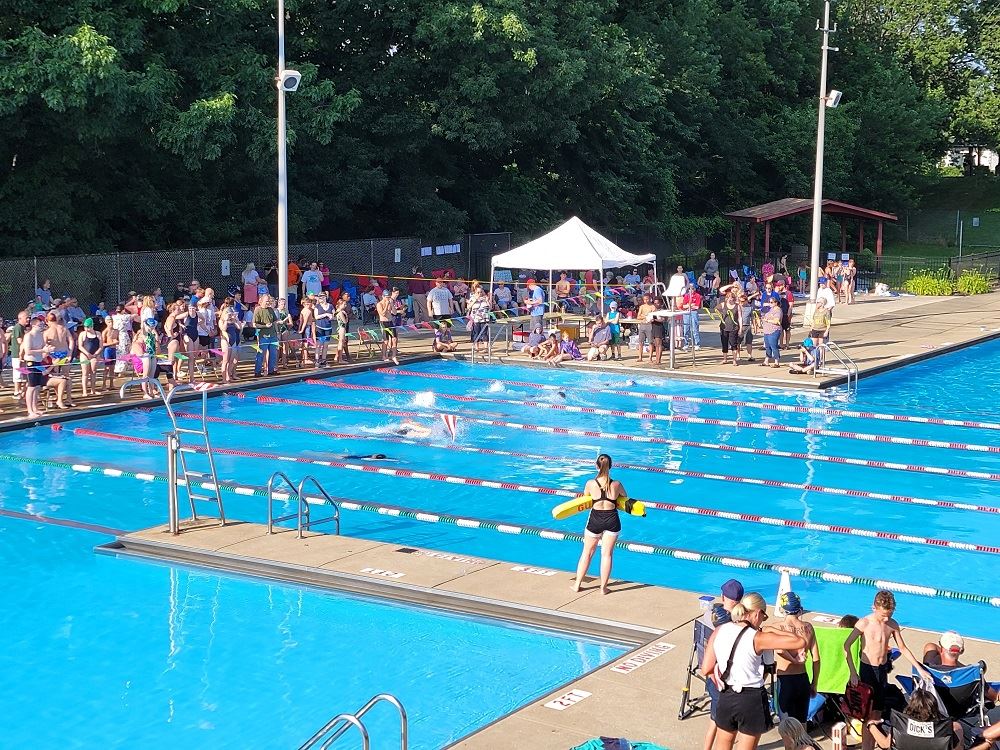 Swimmers Line the Edge of the Pool