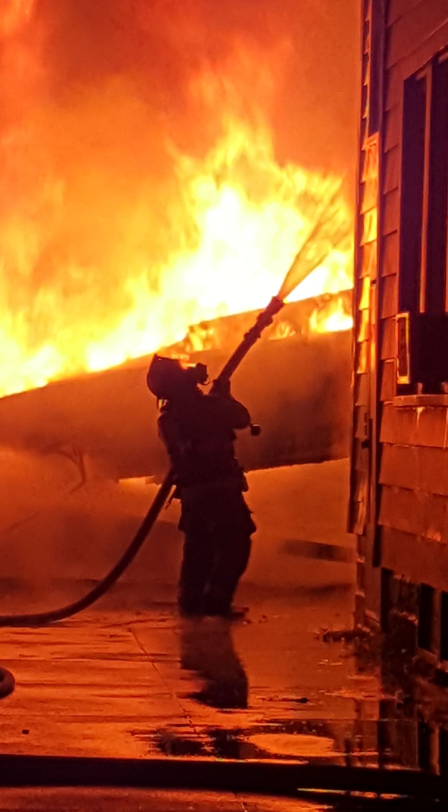 fireman hosing a fire 